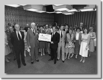 Adam Thomson & Andy Bridgeman, with BCal staff, hand the cheque over to Cancer Reseach's Sir John McKay